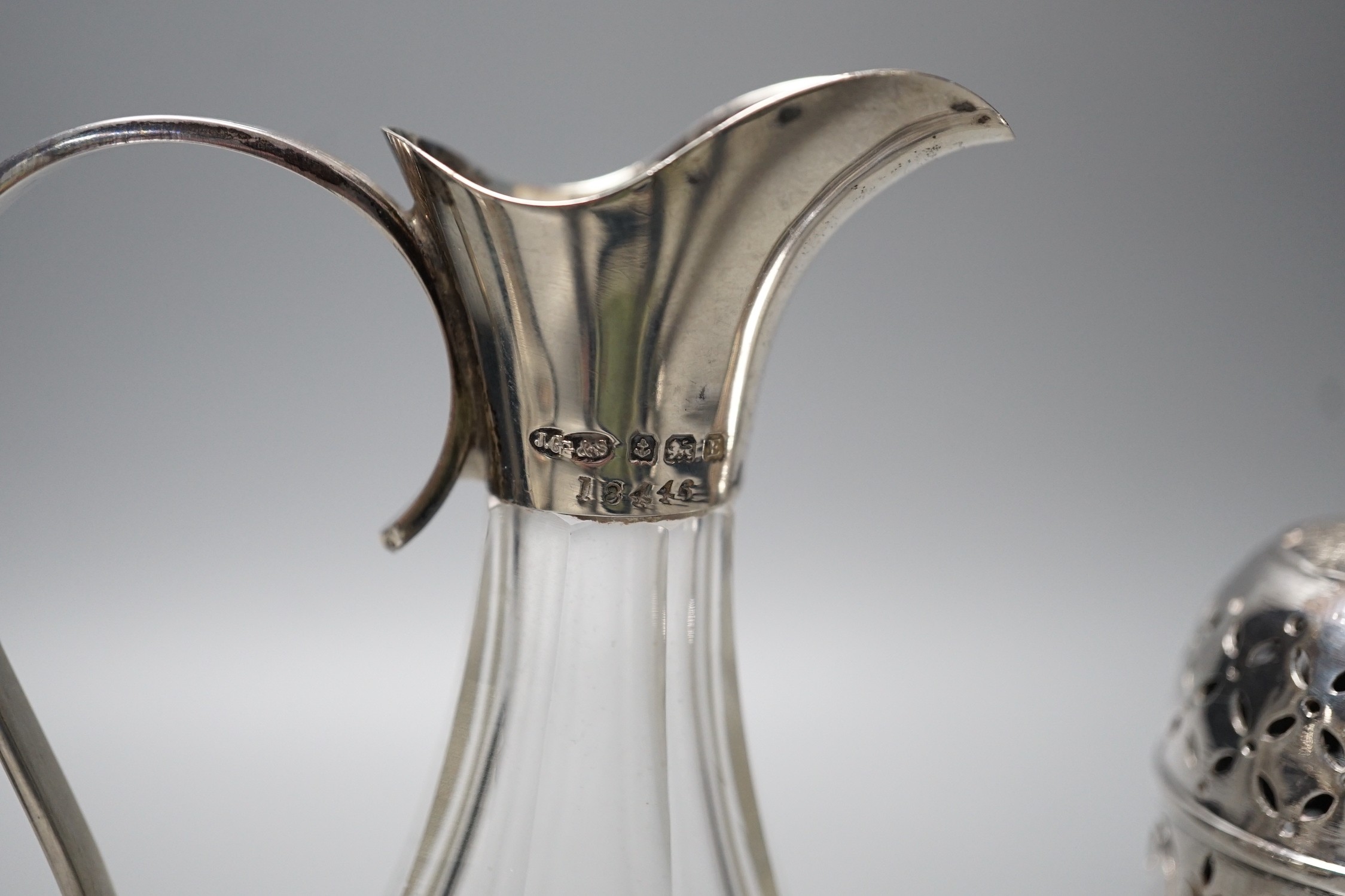 A late Victorian silver helmet shaped cream jug, a silver sugar bowl, a silver mustard pot, a silver mounted posy vase and a silver two handled bowl.